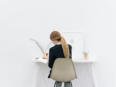 A woman writes in a notebook