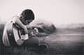 A boy plays on the guitar